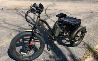 An electric Fat Trike sitting in the street for a picture