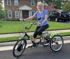 Senior woman smiling on a traditional electric trike after regaining confidence post-surgery — testimonial image for safe trike riding in 2025
